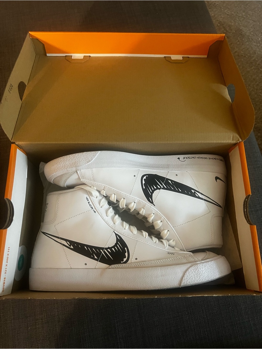 Nike White High-Top Sneakers with Black Graphic Swoosh
